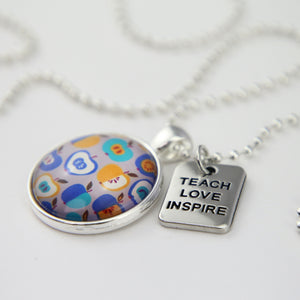 Apple print teach love inspire silver pendant necklace.