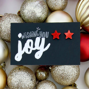 Red glitter star acrylic earring stud on wishing you joy card.