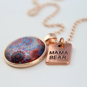 Blue, red and orange patterned print pendant necklace with rose gold ball chain and Mama Bear word charm.