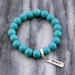 Turquoise stone bead bracelet with silver charms with meaningful words. 