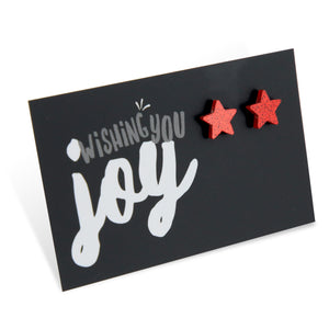 Red glitter star acrylic earring stud on wishing you joy card.