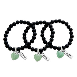 Matt black onyx stone beaded bracelet with feature green adventurine stone heart charm and inspiring word charms in silver.