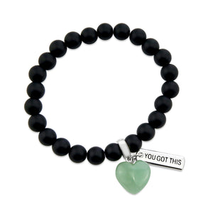 Matt black onyx stone beaded bracelet with feature green adventurine stone heart charm and inspiring word charms in silver.