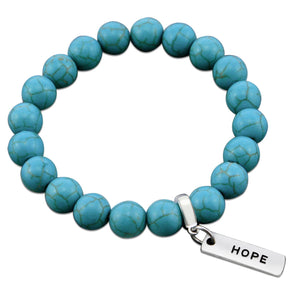 Turquoise stone bead bracelet with silver charms with meaningful words. 