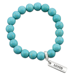 Turquoise stone bead bracelet with silver charms with meaningful words. 