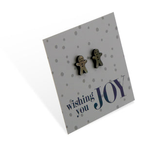 Black stainless steel gingerbread cookies on foil wishing you joy card.